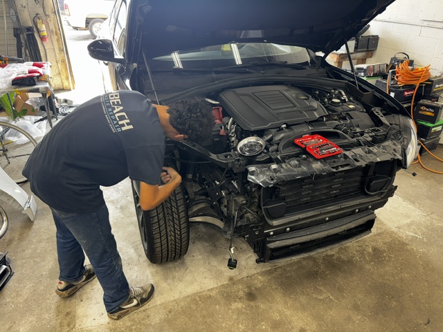 Beach Auto & Transmission Repair technician servicing a Land Rover engine in our Virginia Beach shop