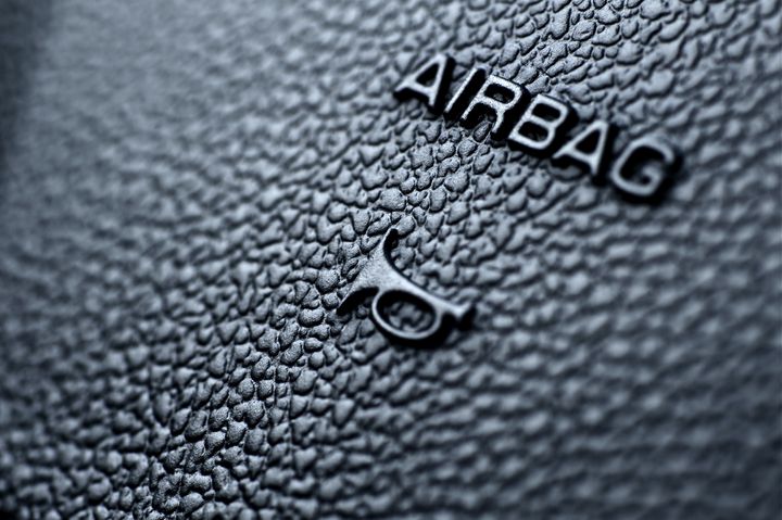 Closeup of a steering wheel with the airbag text