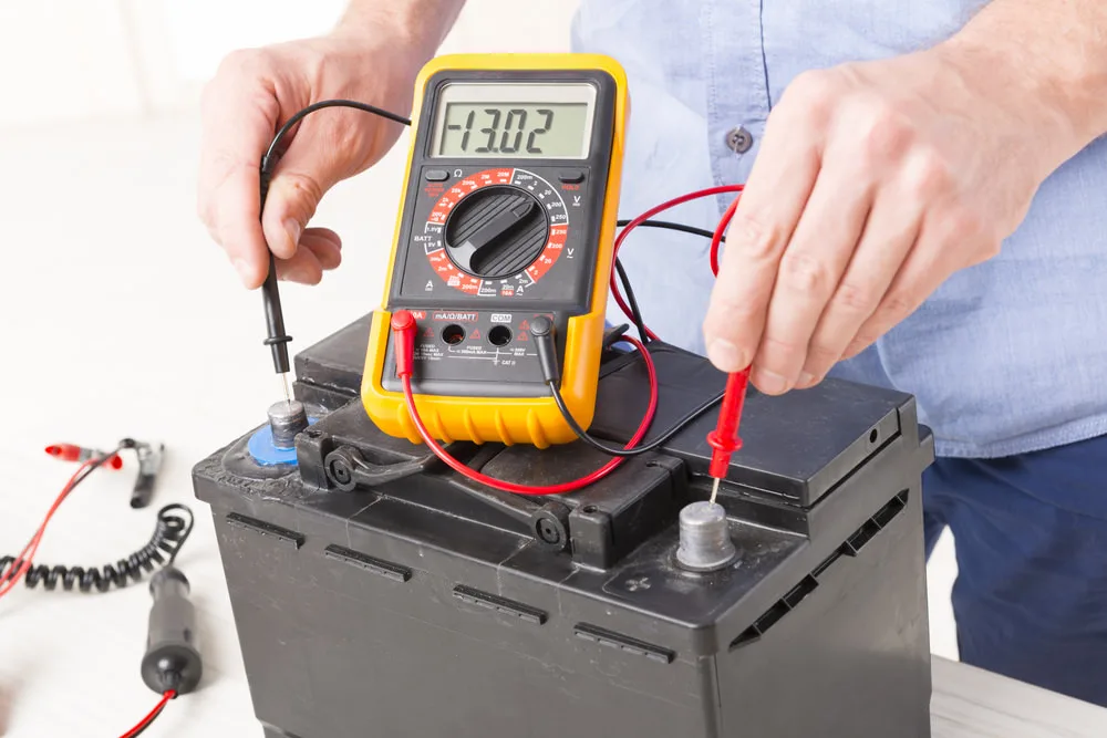 A battery's voltage being checked