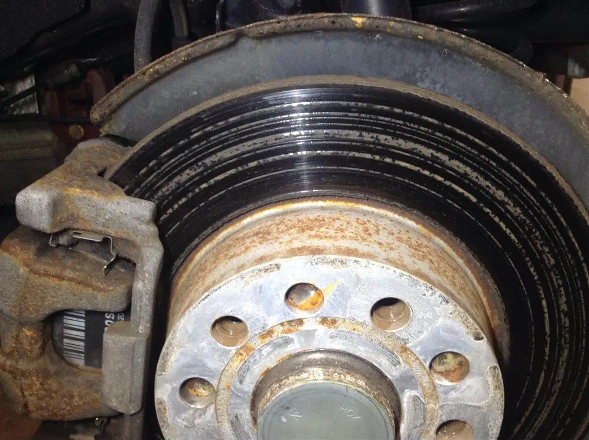 Closeup of rusty brakes and rotors