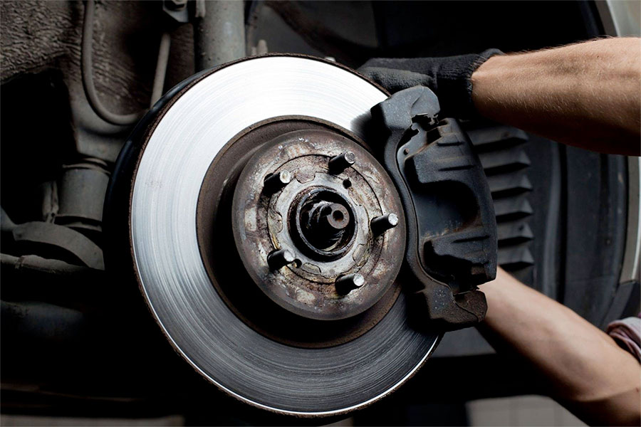 A man servicing brakes and rotors
