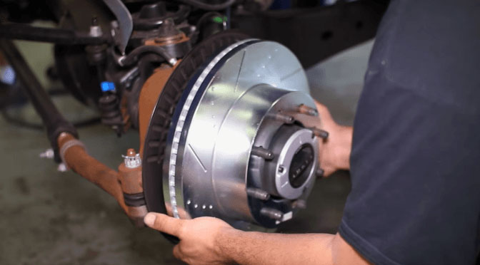 A man servicing brakes and rotors