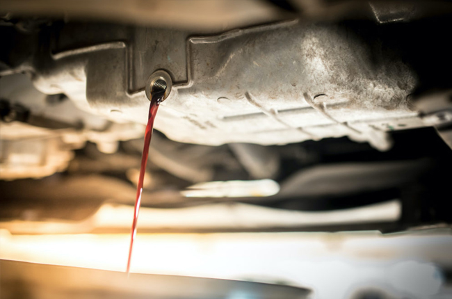 Oil leaking out the bottom of a vehicle