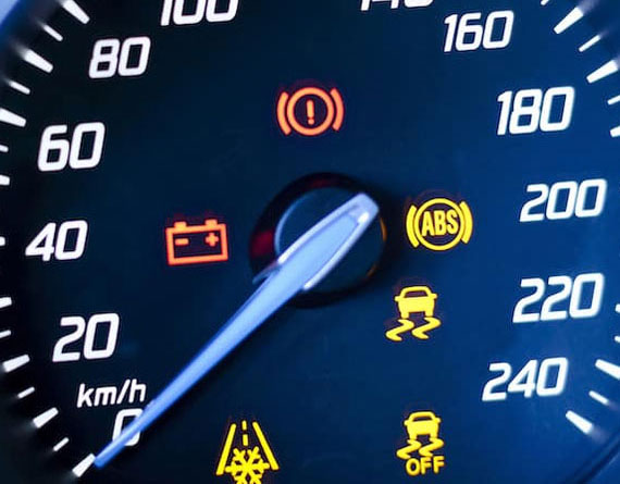 The dashboard of a vehicle with the engine light on