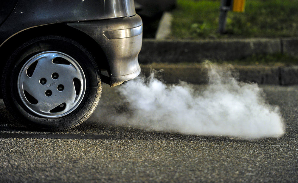 Side view of fumes coming out of a vehicle's exhaust