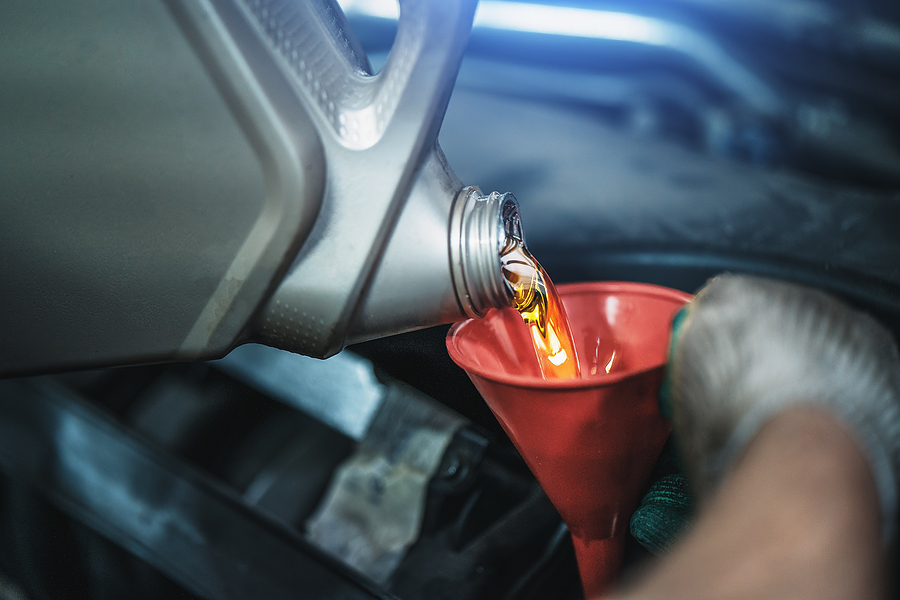 Oil being poured into a funnel