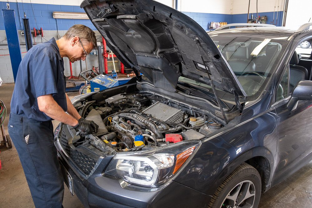 An automotive technician inspecting the internals of a vehicle