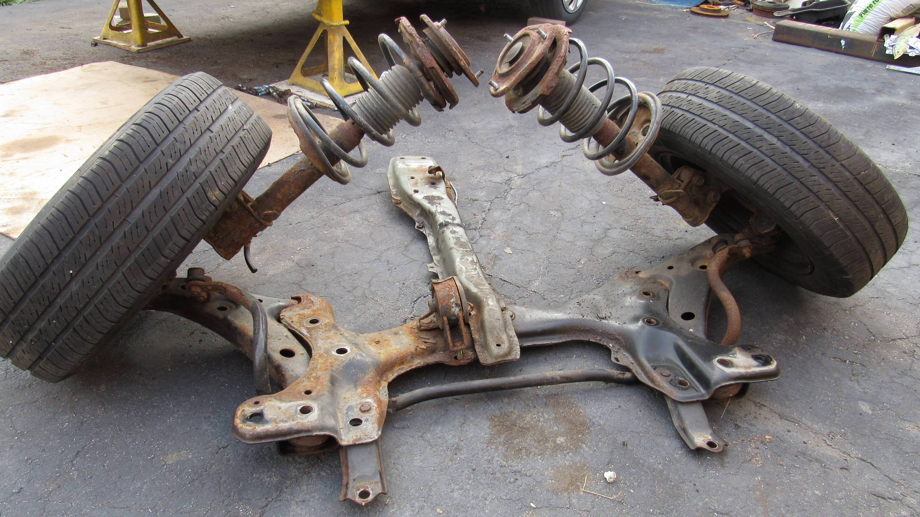 A vehicle's rusty front wheel suspension system