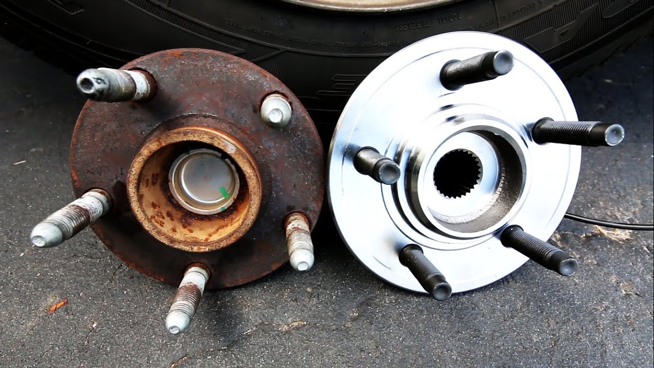 Two wheel bearings next to eachother, one being very dirty and rusty, and the other very clean and shiny