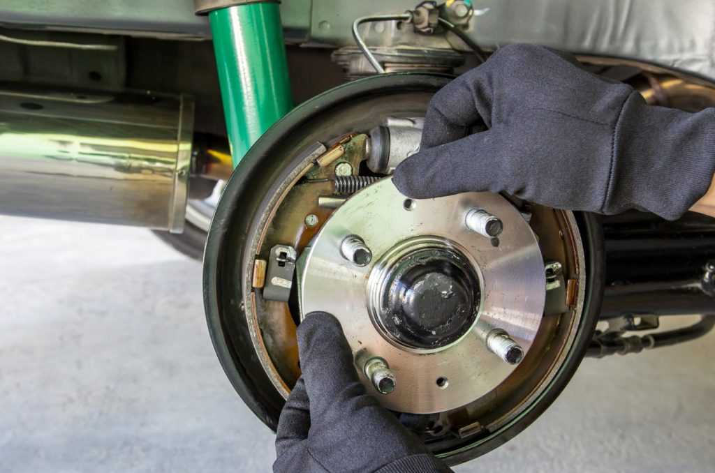 An automotive technician replacing a wheel bearing