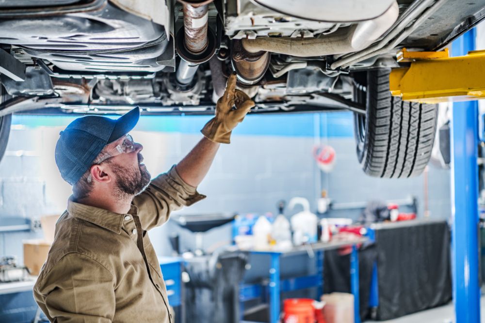 Man inspecting a catalytic converter