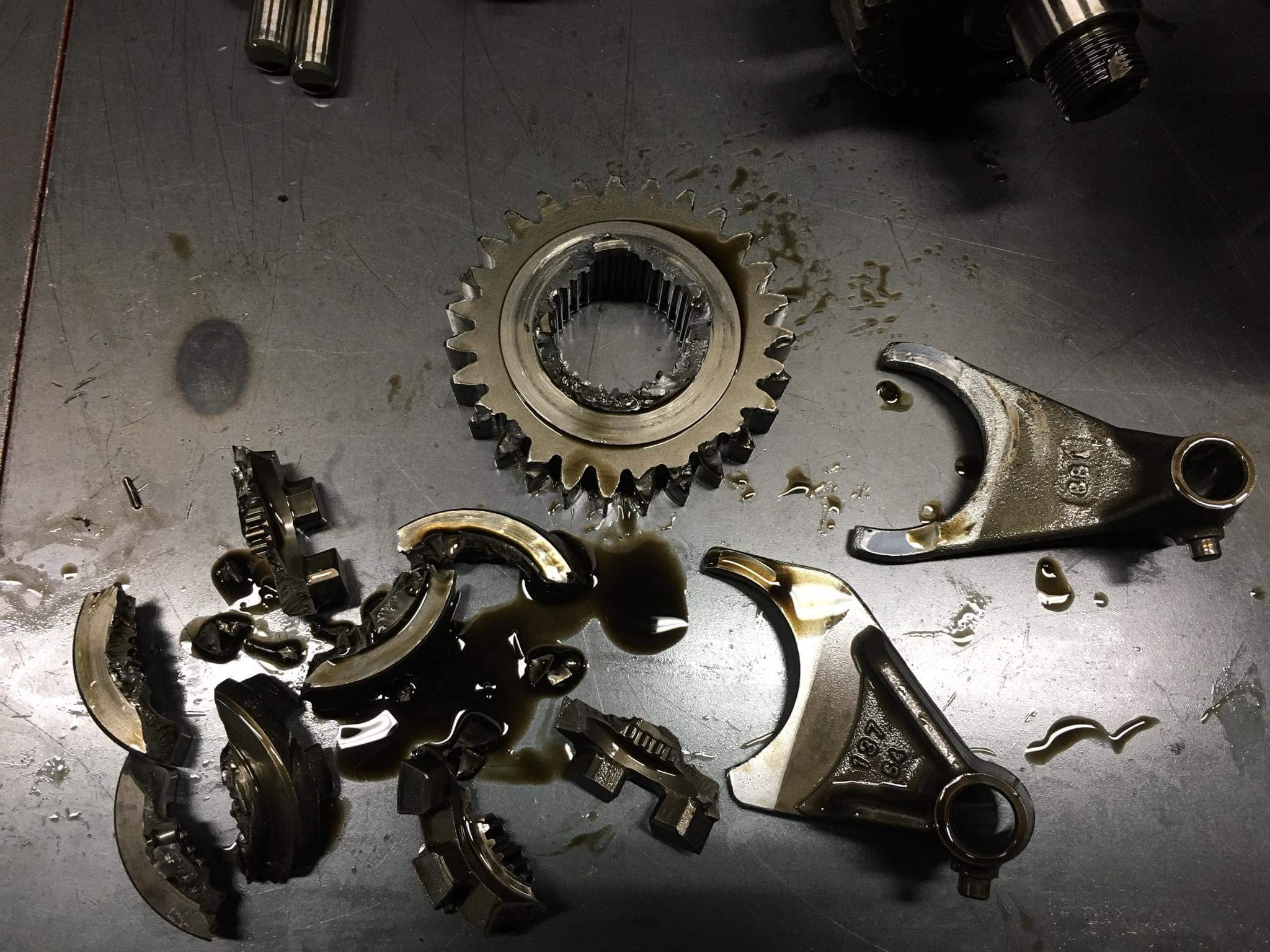 Transmission parts on a table covered in grease