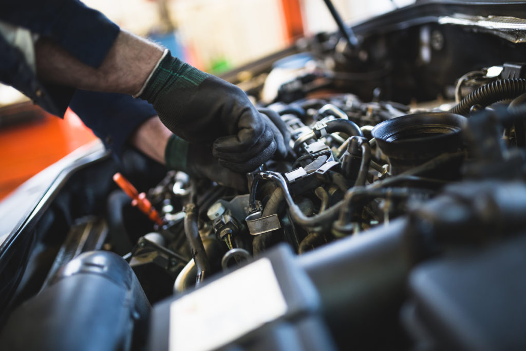 An automotive technician servicing a vehicle