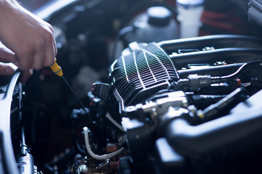 An automotive technician inspecting a vehicle's engine