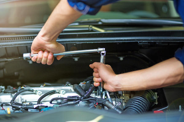 An automotive technician tightening bolts