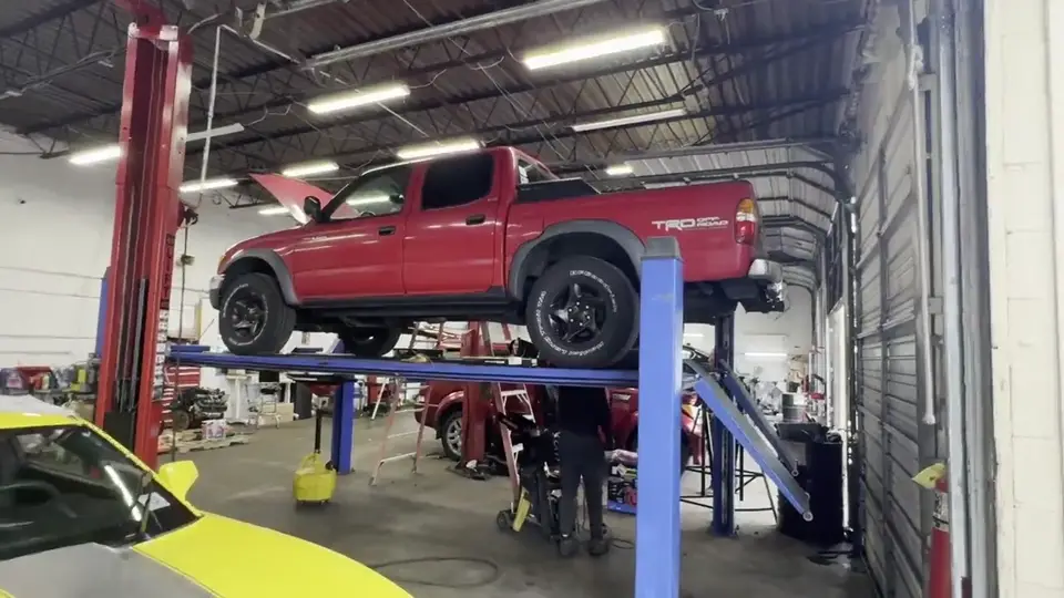 Red pickup truck being serviced at Beach Auto & Transmission Repair