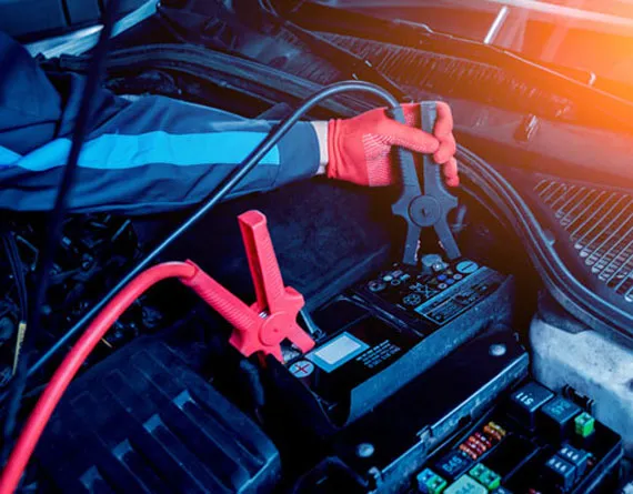 Car battery and electrical system being tested with diagnostic equipment at Beach Auto & Transmission Repair