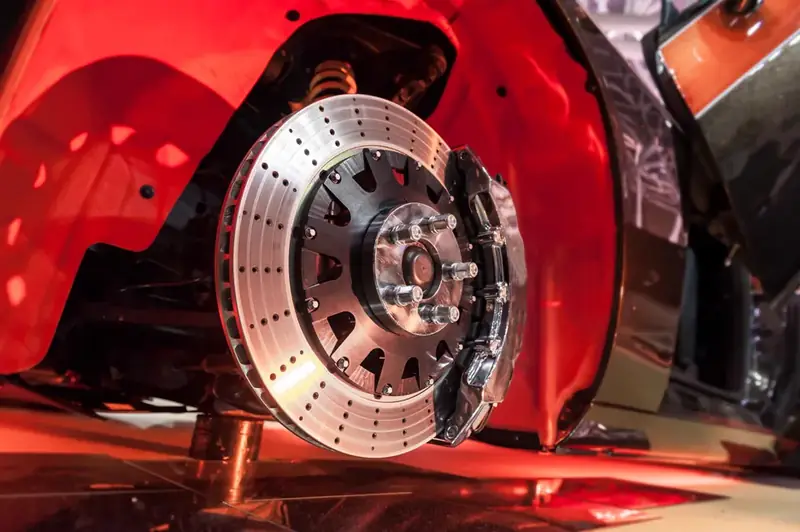 Brake pads and rotors being inspected during a free brake check at Beach Auto & Transmission Repair