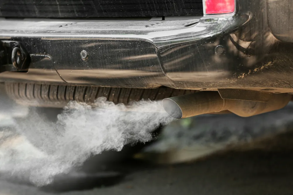 Muffler and exhaust pipe system on a vehicle lift being repaired at an auto shop