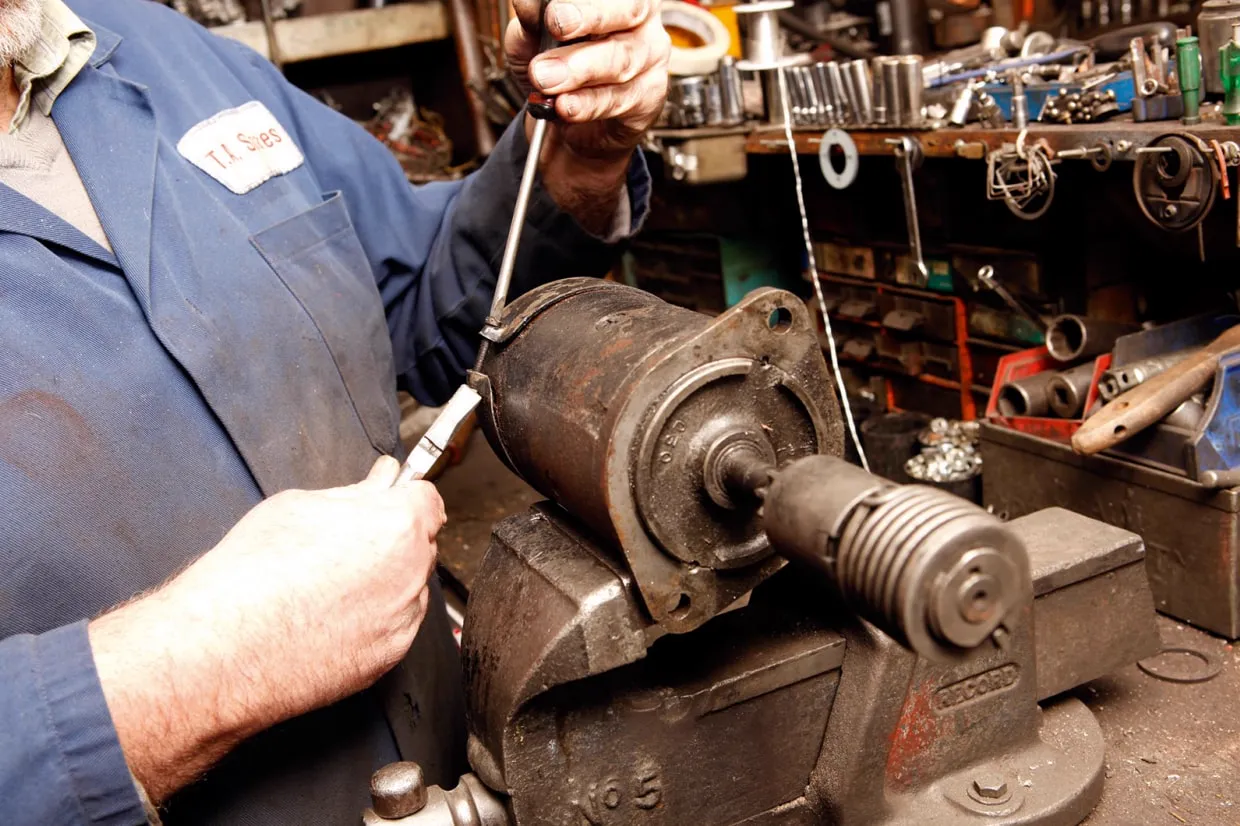 Starter motor being tested and replaced on a vehicle at a Virginia Beach repair shop