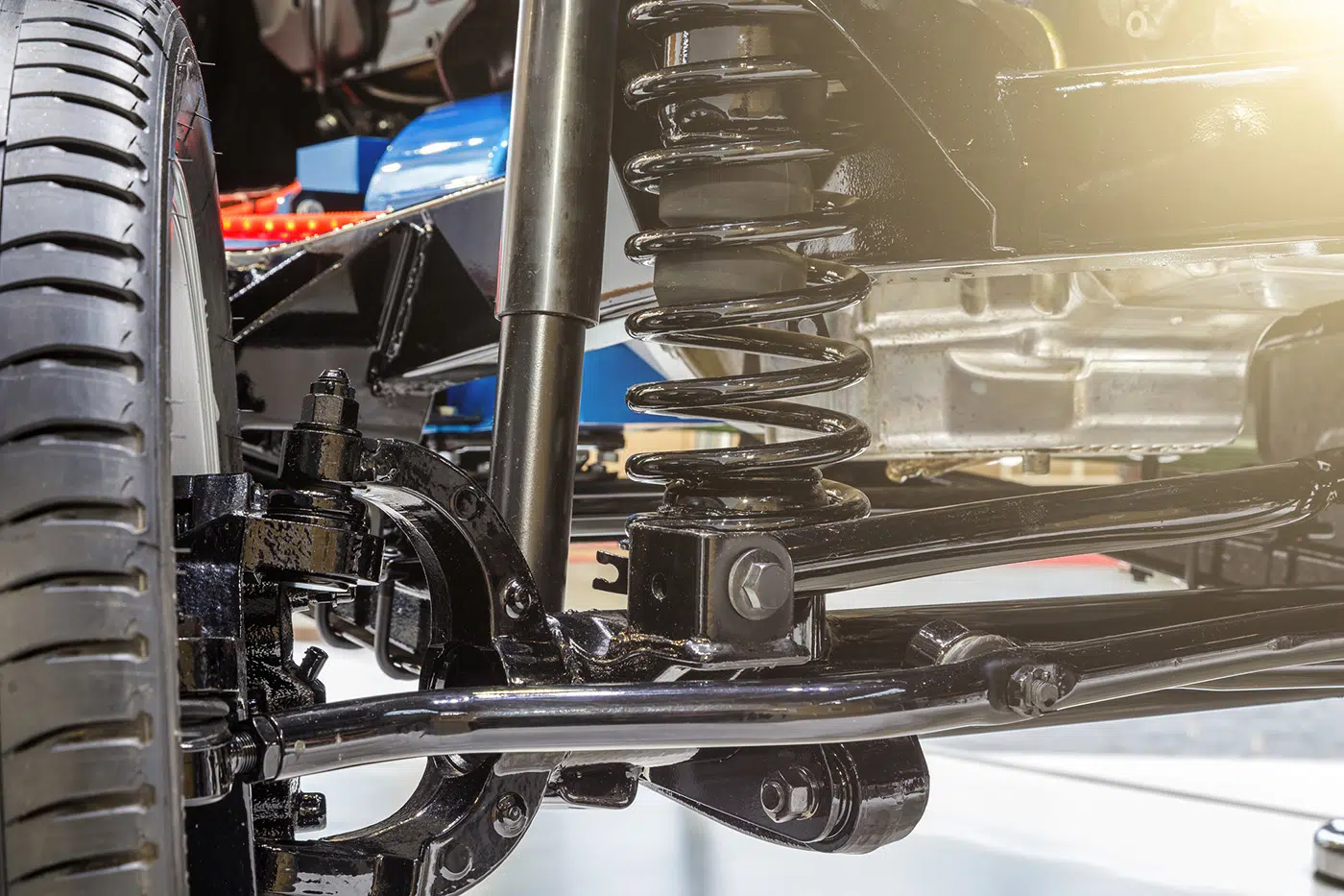 Suspension components including struts, wheel bearings and ball joints being inspected on a lift